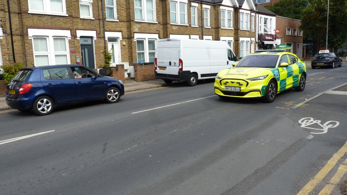 Ambulance car rushing on Kingston Road with flashing lights during emergency