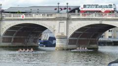 Kingston Bridge over the River Thames with boats and lush green trees