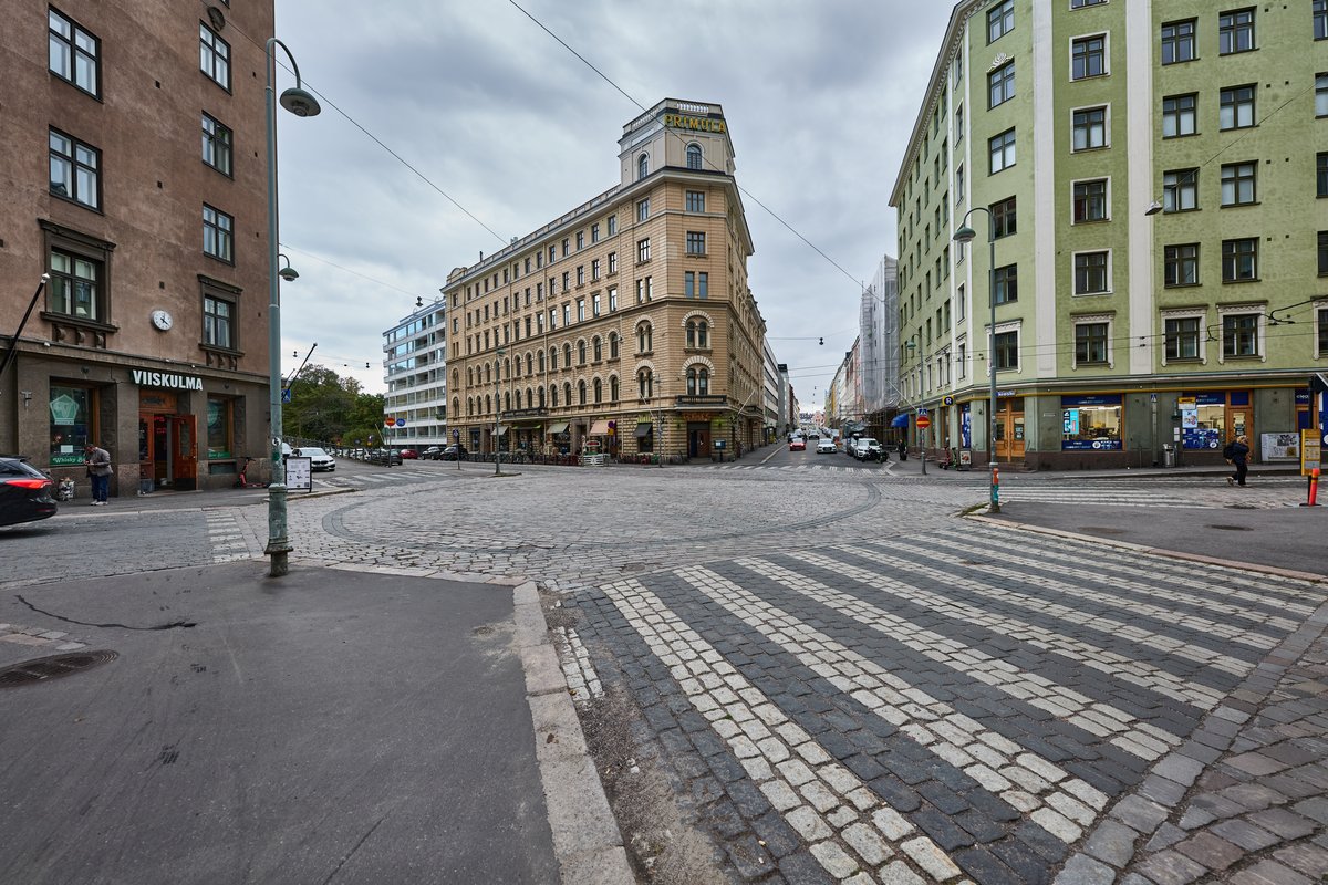 Viiskulma square in Helsinki with colorful buildings and a cloudy sky
