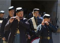Five male Civil War reenactors marching and playing period instruments