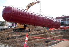 35,000-gallon rainwater collection tank installed next to new LEED silver rated instruction building under construction at Presidio of Monterey