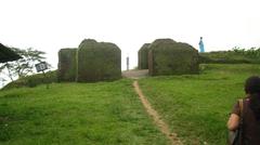 Ita Fort in Itanagar with ancient brick walls surrounded by green trees under blue sky