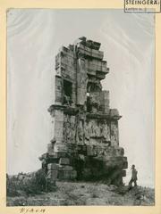 Monument of Philopappos on the Hill of the Muses near the Acropolis with visible reliefs and a person at the base for scale