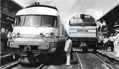 First westbound Lake Cities train arriving at Detroit in August 1980 with exhibition train of new equipment at right