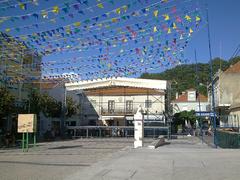 Stage at Festas de São Pedro da Trafaria with colorful decorations and crowd