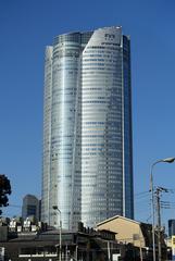 Mori Tower in Roppongi Tokyo Japan under blue sky with surrounding cityscape