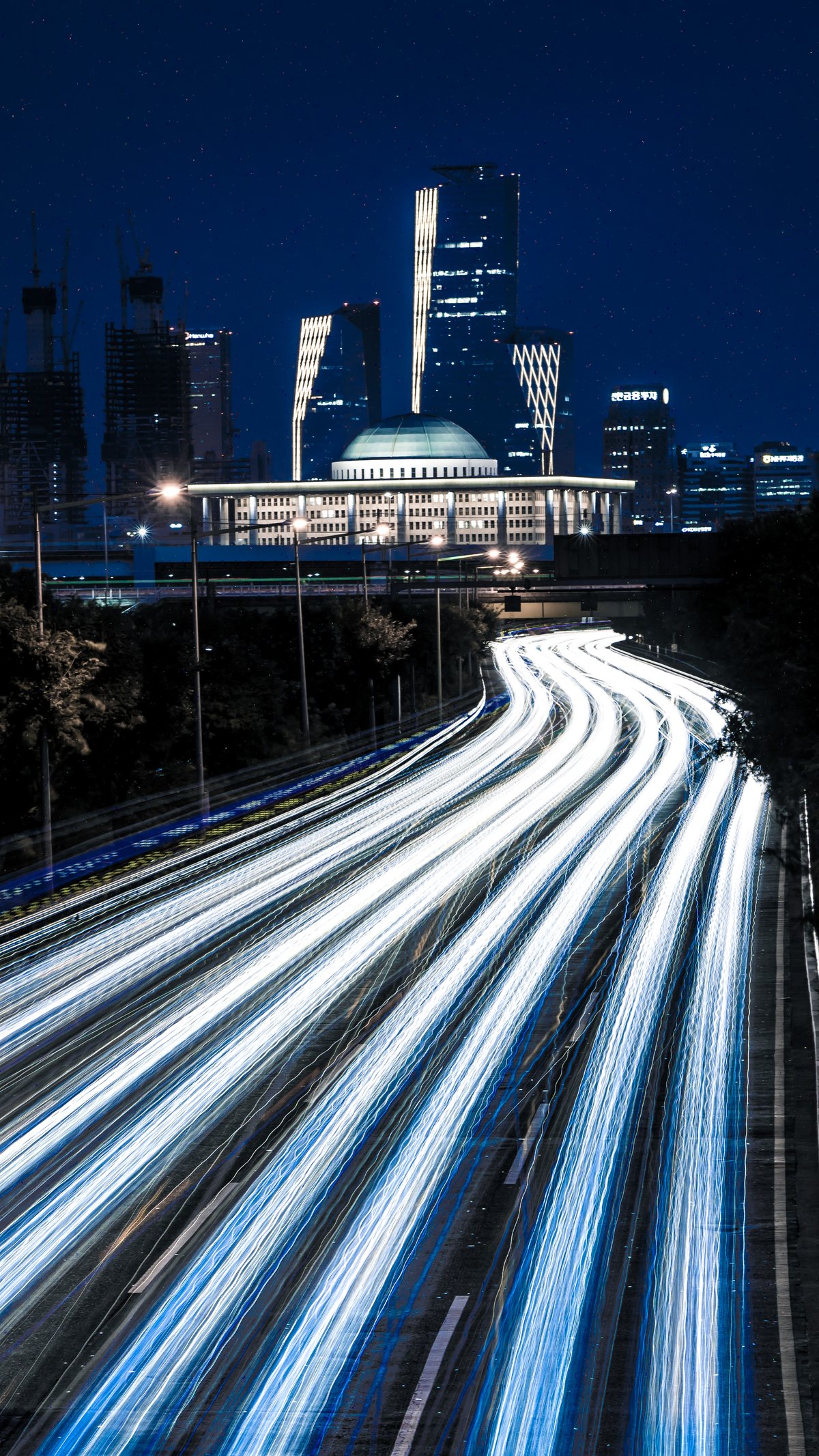 Night view of Olympic Boulevard Expressway with light trails from moving vehicles in Seoul