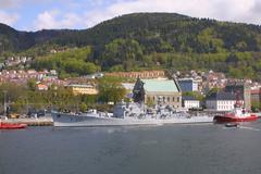 HNoMS Bergen docked in Bergen, Norway with Bergenhus Fortress in the background
