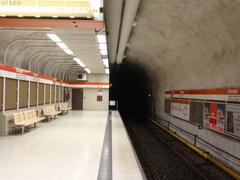 Kamppi metro station platform with yellow lighting and passengers in Helsinki