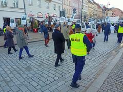 Demonstration in Warsaw city square with people holding banners and flags on April 10, 2023