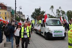 Farmers protest in Warsaw with people holding banners and flags