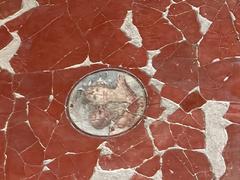 Detailed close-up of an ancient fresco at Herculaneum featuring intricate artwork and vibrant colors