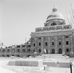 Snow-covered Hofgarten park with the ruins of the Bayerische Staatskanzlei in Munich during winter
