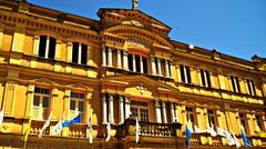 Front view of Seminário Apostólico de Manhumirim building with trees in the foreground