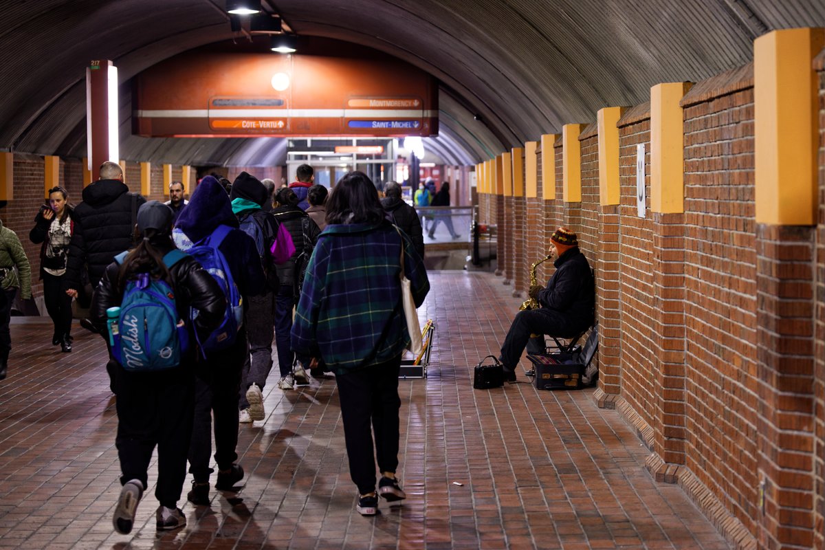Saxophonist playing saxophone at Snowdon station outdoors