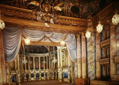 Royal Opera stage at Palace of Versailles with ornate golden decorations and luxurious red curtains