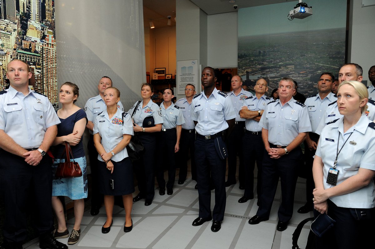 General Edward Rice and U.S. Airmen watching World Trade Center video at 9/11 Tribute Center