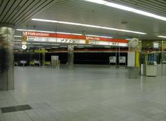 Interior view of Hakaniemi metro station in Helsinki with escalators and ceiling lights