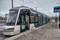 New modern tram running on fresh tracks in Helsinki suburbs on a winter day
