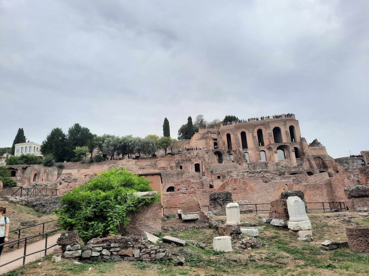 Panoramic view of historic Rome cityscape with ancient ruins and buildings under clear blue sky