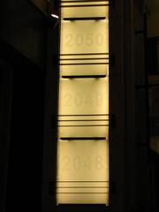 Oscar statuettes on display with vacant slots labeled 2048, 2049, and 2050