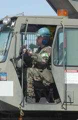 TSgt Rob Jalbert operating a 60-ton crane at Yokota Air Base to hoist a crippled C-130 Hercules aircraft during a combat readiness exercise