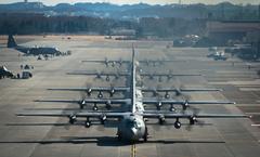 Six U.S. Air Force C-130 Hercules aircraft lined up at Yokota Air Base Japan