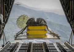 Heavy equipment payload dropping from U.S. Air Force C-130H Hercules aircraft during Max Thunder 14-1 exercise over South Korea