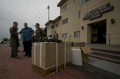 Deputy Secretary of Defense Bob Work being briefed on Low Altitude Airdrop Delivery System at Yokota Air Base Japan