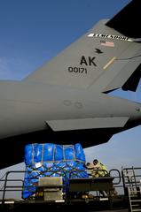 U.S. Air Force personnel loading supplies onto C-17 Globemaster III at Yokota Air Base for Japan earthquake tsunami relief