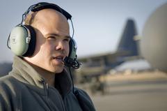 Senior Airman Ramon Mortensen of the 17th Special Operations Squadron discussing preflight checklist with pilot before mission to Sendai Airport Japan