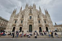 Milan Cathedral exterior with intricate gothic architecture under clear sky