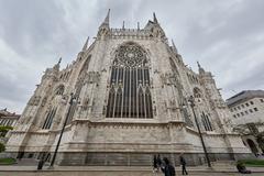 Milan Cathedral exterior with intricate Gothic architecture under clear sky