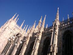 Milan Cathedral Duomo di Milano Gothic architecture with spires and statues under blue sky