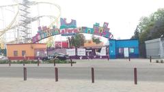 Entrance of Feria de Chapultepec amusement park with roller coaster tracks visible