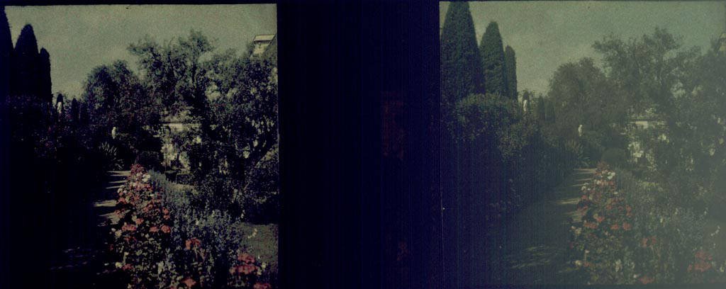 View of the gardens at Palau Reial de Pedralbes in Barcelona with lush greenery and stone pathways