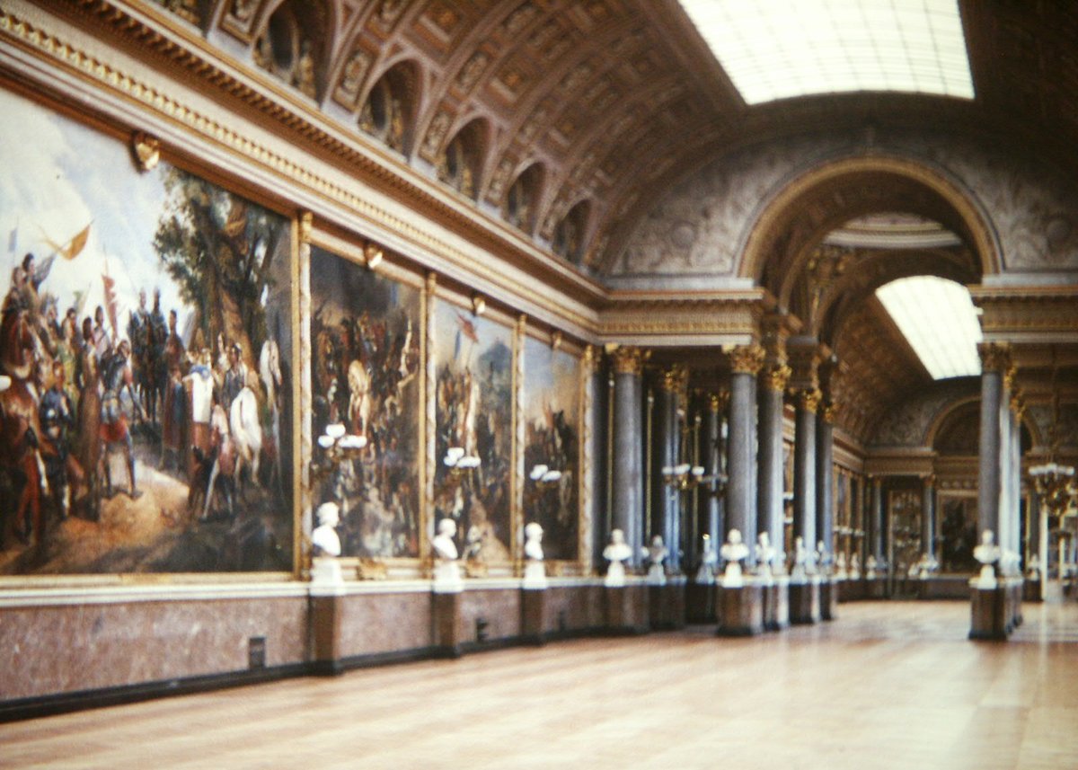 Interior view of Galerie des Batailles at the Palace of Versailles with detailed paintings and sculptures