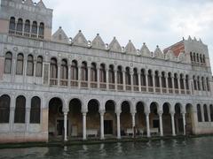 A picturesque scene in Venice, Italy featuring a gondola on a calm canal with historic buildings and arched stone bridge
