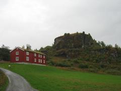 Sverresborg hill with lush greenery and historic ruins under a blue sky