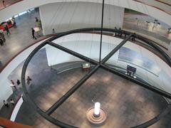 Modern stairway inside Hanoi Museum with reflective ceiling and handrails