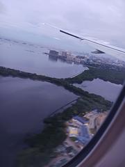 Airplane landing at Manila airport with Las Piñas-Parañaque Critical Habitat and Ecotourism Area in the background