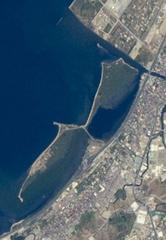 Oblique astronaut photograph of Manila and surrounding cities showing urban pattern, Manila Bay with docks, Laguna de Bay, Pasig River, and forested nature reserve
