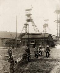 Rescue team wearing oxygen masks carries deceased miners on stretchers after 1921 Mont Cenis mine disaster in Herne, Westfalen
