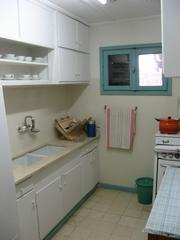 Interior kitchen of David Ben Gurion's shack with vintage utensils and rustic design