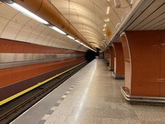 Křižíkova metro station platform with signage and tracks