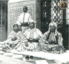 Moroccan women in traditional caftan sitting in a patio of Moroccan Riad in Tetouan 1920