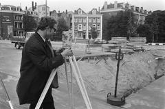 Surveyor working at Rhijnspoorplein during Amsterdam Metro press excursion in 1970 black and white photo