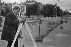 Amsterdam land surveyor working at Rhijnspoorplein during city metro excursion in 1970