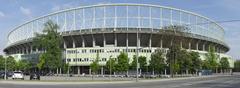 A panoramic view of the Ernst-Happel-Stadion with bright stadium lights illuminating the field during an event