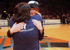 Petty Officer 3rd Class Dana Cox embraces her mother Diana Russell during a New York Knicks basketball game in Manhattan as part of a military appreciation event